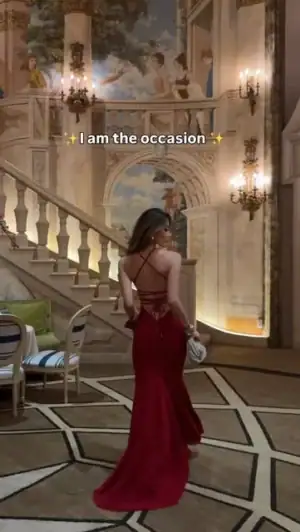 Kerina Wang in deep red Babyboo Olenia evening gown, open lace-up back, ballroom staircase