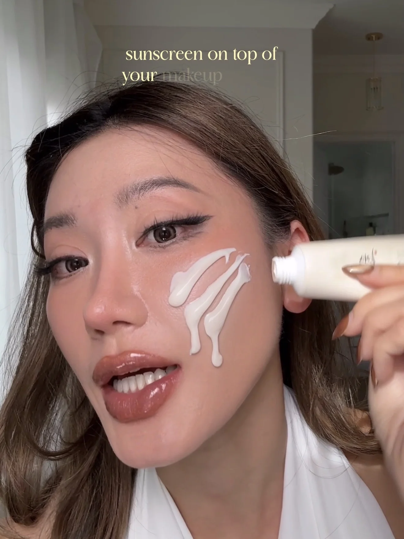 Kerina applying sunscreen on top of makeup